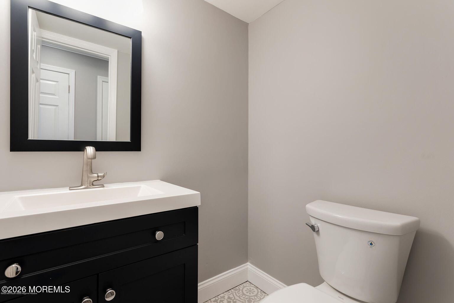 23 Sami Drive Howell, NJ 07731 - Photo 17 of 26 a bathroom with a toilet a sink and mirror