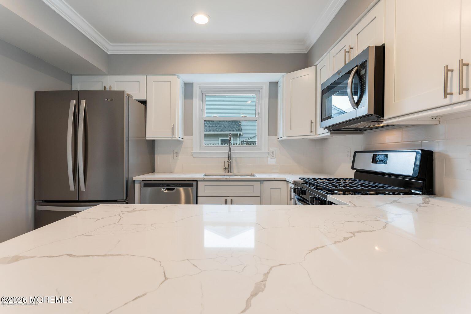 23 Sami Drive Howell, NJ 07731 - Photo 20 of 26 a kitchen with stainless steel appliances granite countertop a refrigerator a stove and a sink