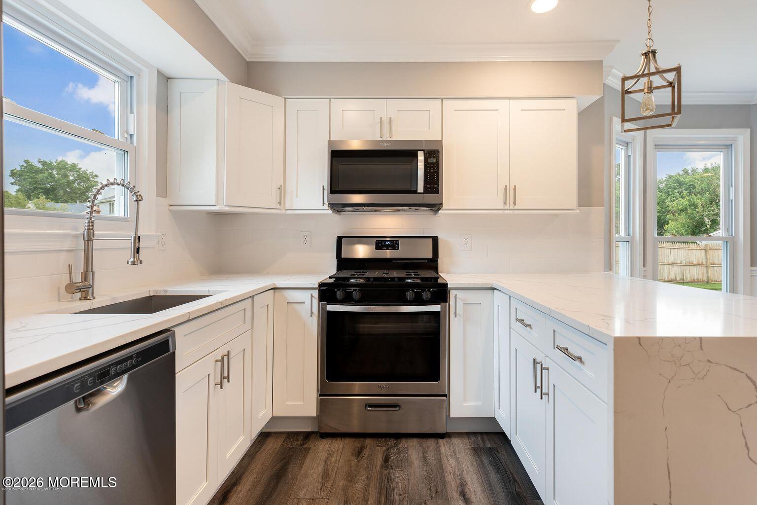 23 Sami Drive Howell, NJ 07731 - Photo 21 of 26 a kitchen with a sink stove and microwave