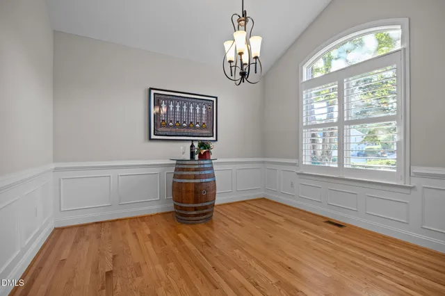 a kitchen with stainless steel appliances granite countertop a stove top oven a sink a refrigerator and white cabinets