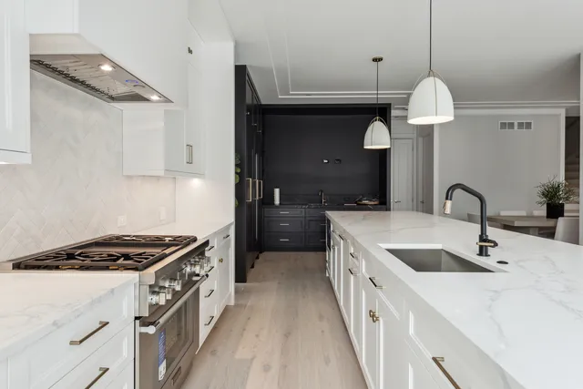 a kitchen with granite countertop a sink stove and cabinets