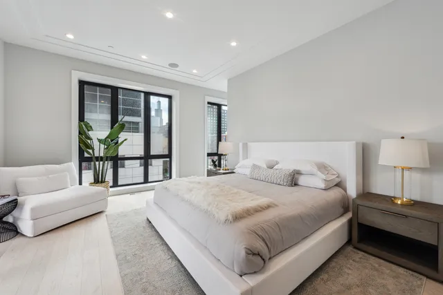 a spacious bedroom with a bed and a couch