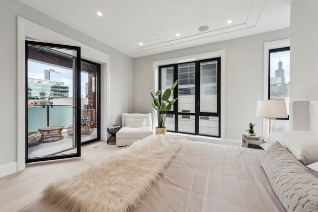 a spacious bedroom with a large bed and a large window