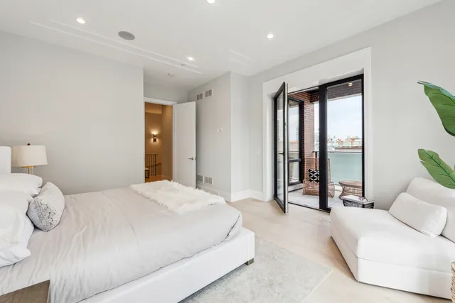 a spacious bedroom with a large bed and a large window