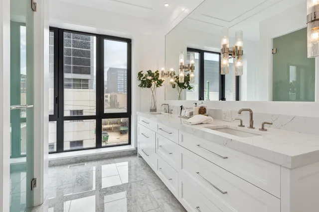 a bathroom with double vanity sinks and a large mirror