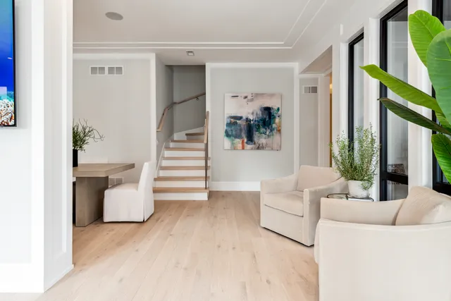 a living room with furniture and a hallway