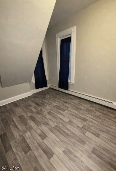 942 East 19th Street Paterson, NJ 07501 - Photo 13 of 26 a view of an empty room with wooden floor and a window
