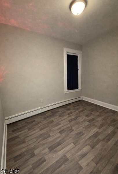 942 East 19th Street Paterson, NJ 07501 - Photo 14 of 26 a view of an empty room with wooden floor and a window