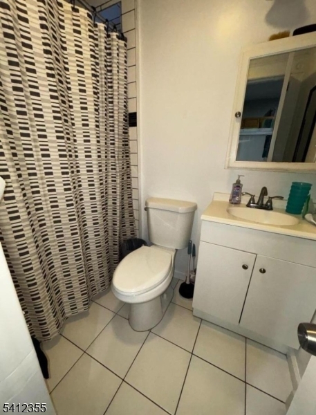 942 East 19th Street Paterson, NJ 07501 - Photo 15 of 26 a bathroom with a toilet and a sink