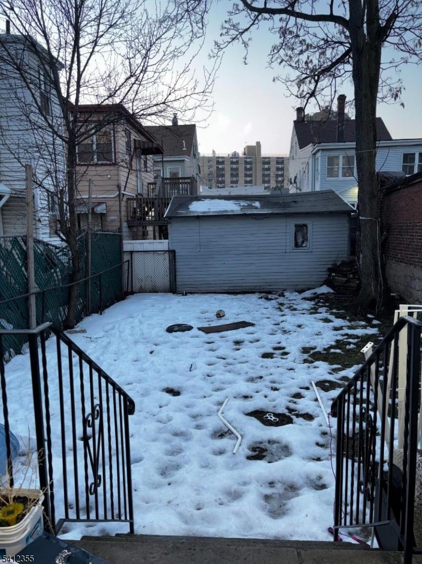 942 East 19th Street Paterson, NJ 07501 - Photo 20 of 26 a view of a terrace with wooden floor and fence