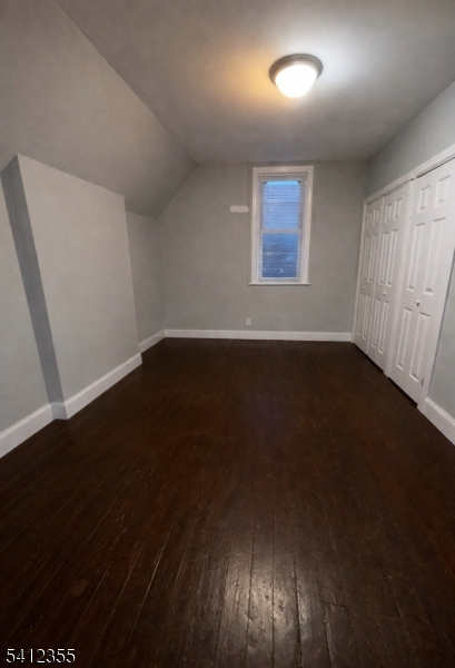 942 East 19th Street Paterson, NJ 07501 - Photo 21 of 26 an empty room with wooden floor and windows