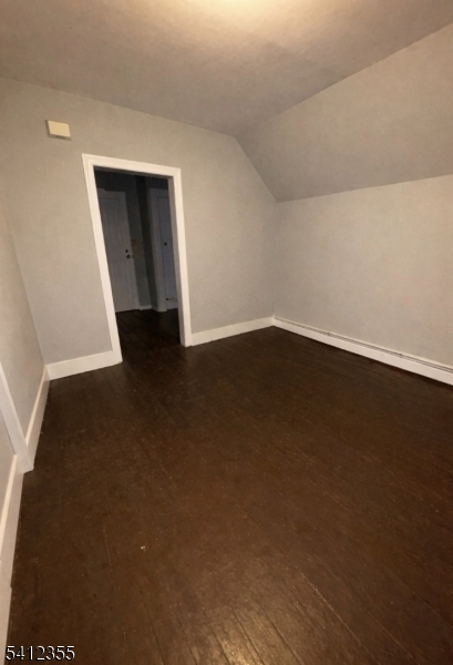 942 East 19th Street Paterson, NJ 07501 - Photo 24 of 26 a view of an empty room with wooden floor and a window