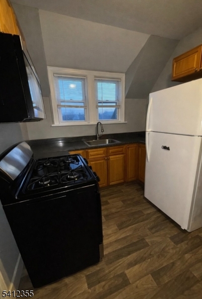 942 East 19th Street Paterson, NJ 07501 - Photo 25 of 26 a kitchen with a stove and a refrigerator