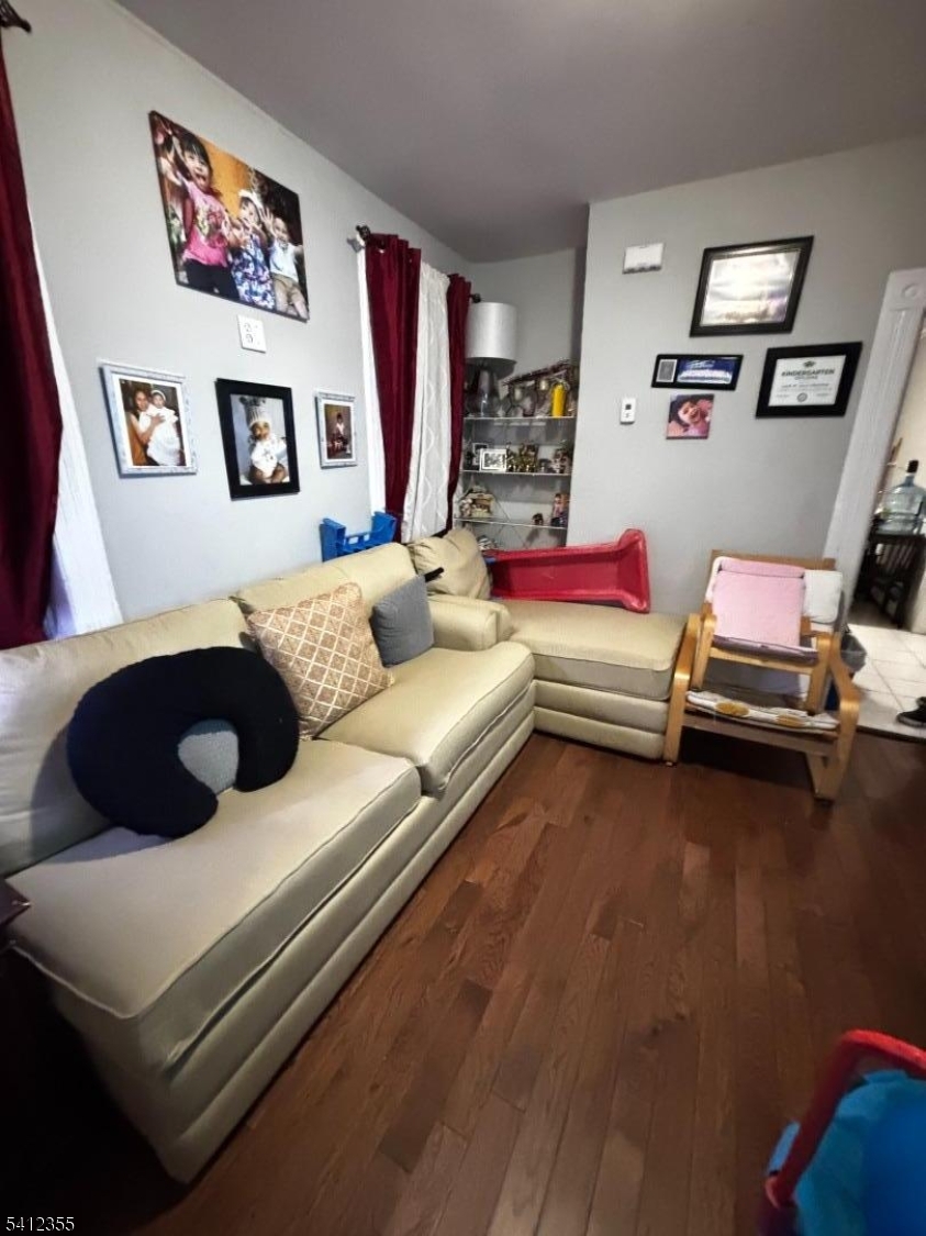 942 East 19th Street Paterson, NJ 07501 - Photo 3 of 26 a living room with furniture and wooden floor