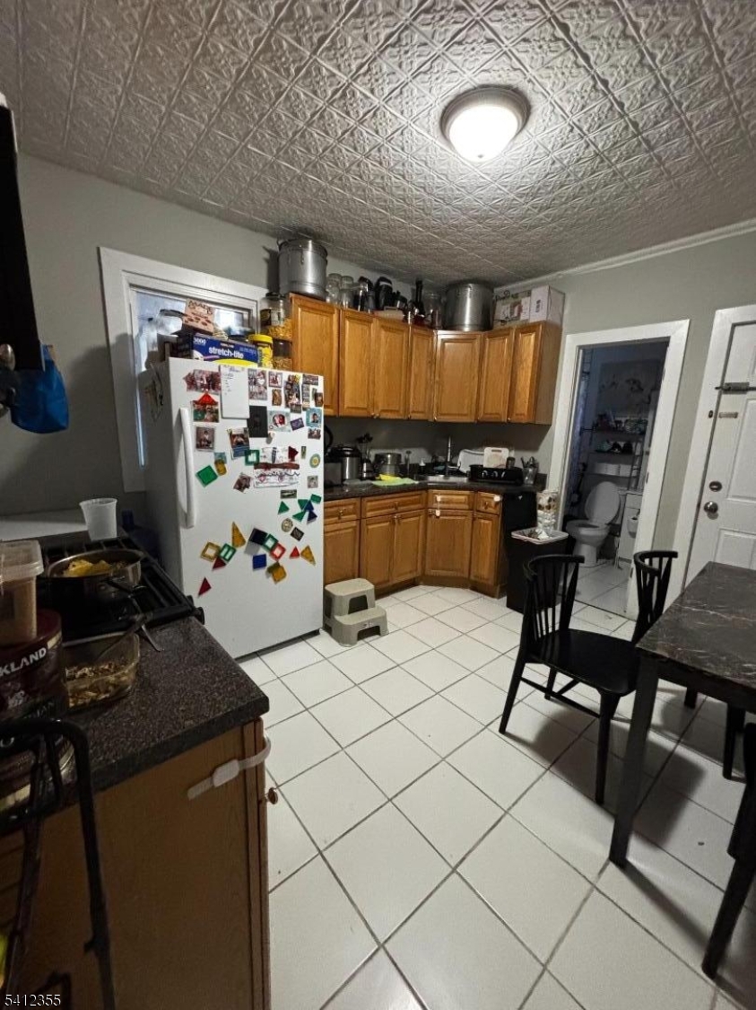 942 East 19th Street Paterson, NJ 07501 - Photo 4 of 26 a kitchen with table and chairs