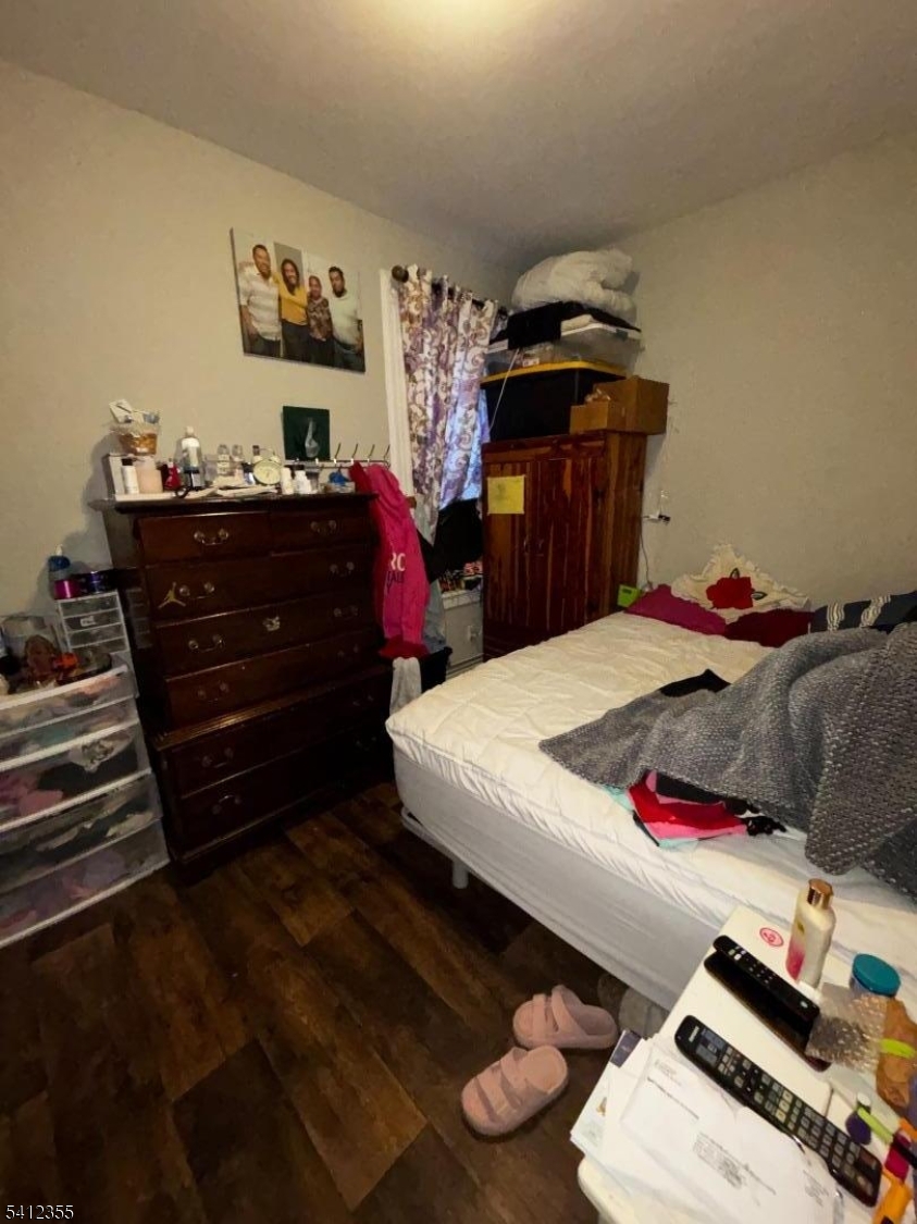 942 East 19th Street Paterson, NJ 07501 - Photo 6 of 26 a bed sitting in a bedroom and dresser