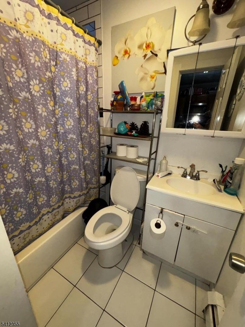 942 East 19th Street Paterson, NJ 07501 - Photo 7 of 26 a bathroom with a sink toilet and shower