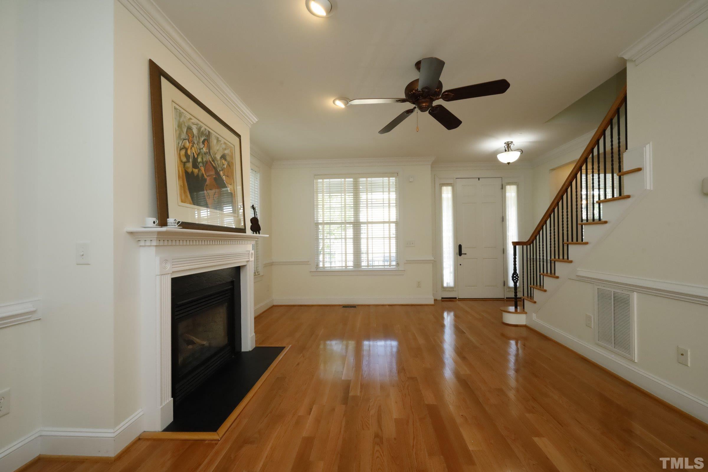 1138 Haynes Street Raleigh, NC 27604 - Photo 8 of 55 a view of empty room with wooden floor and fireplace