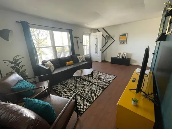 a living room with furniture and a potted plant
