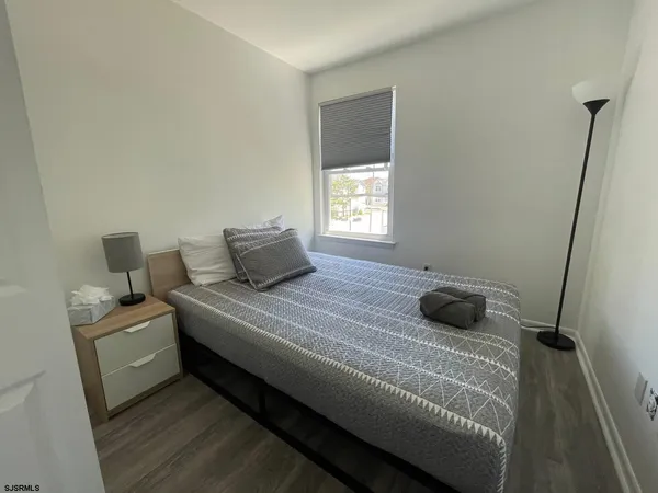 a bedroom with two beds and a window