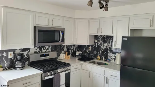 a kitchen with a table and chairs