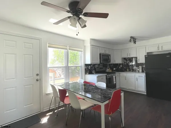 a kitchen with a stove a sink and a refrigerator