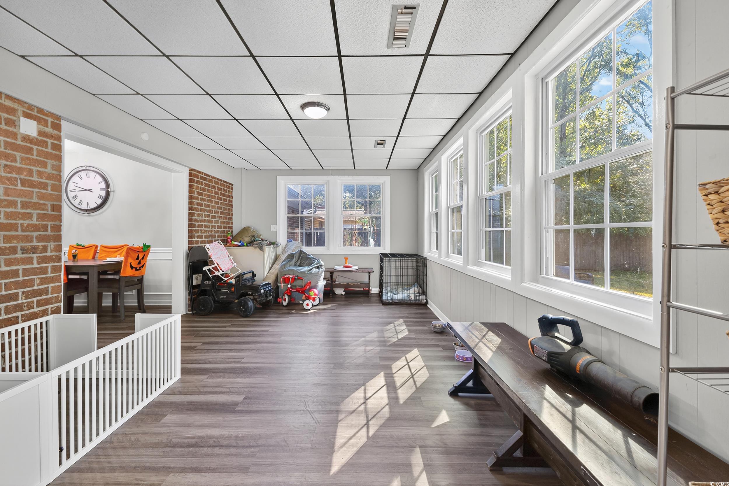 342 Red Fox Road Myrtle Beach, SC 29579 - Photo 22 of 40 Sunroom with wood finished floors, a paneled ceiling, and a wainscoted wall