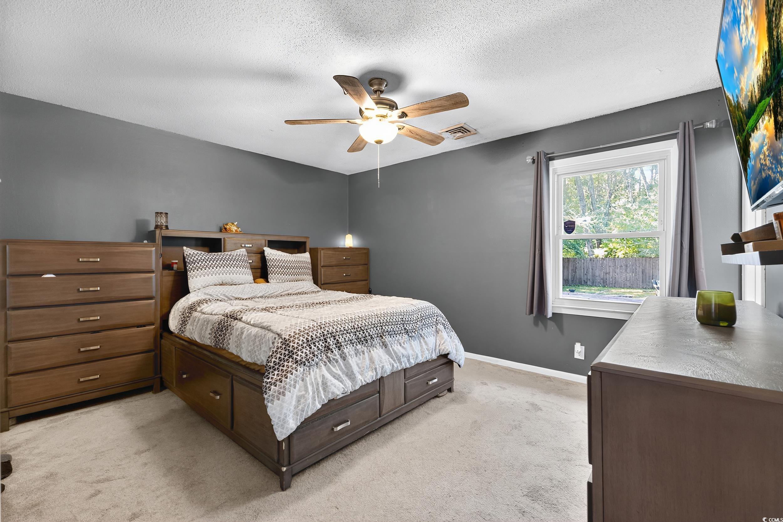 342 Red Fox Road Myrtle Beach, SC 29579 - Photo 24 of 40 Bedroom featuring light carpet, a textured ceiling, and ceiling fan