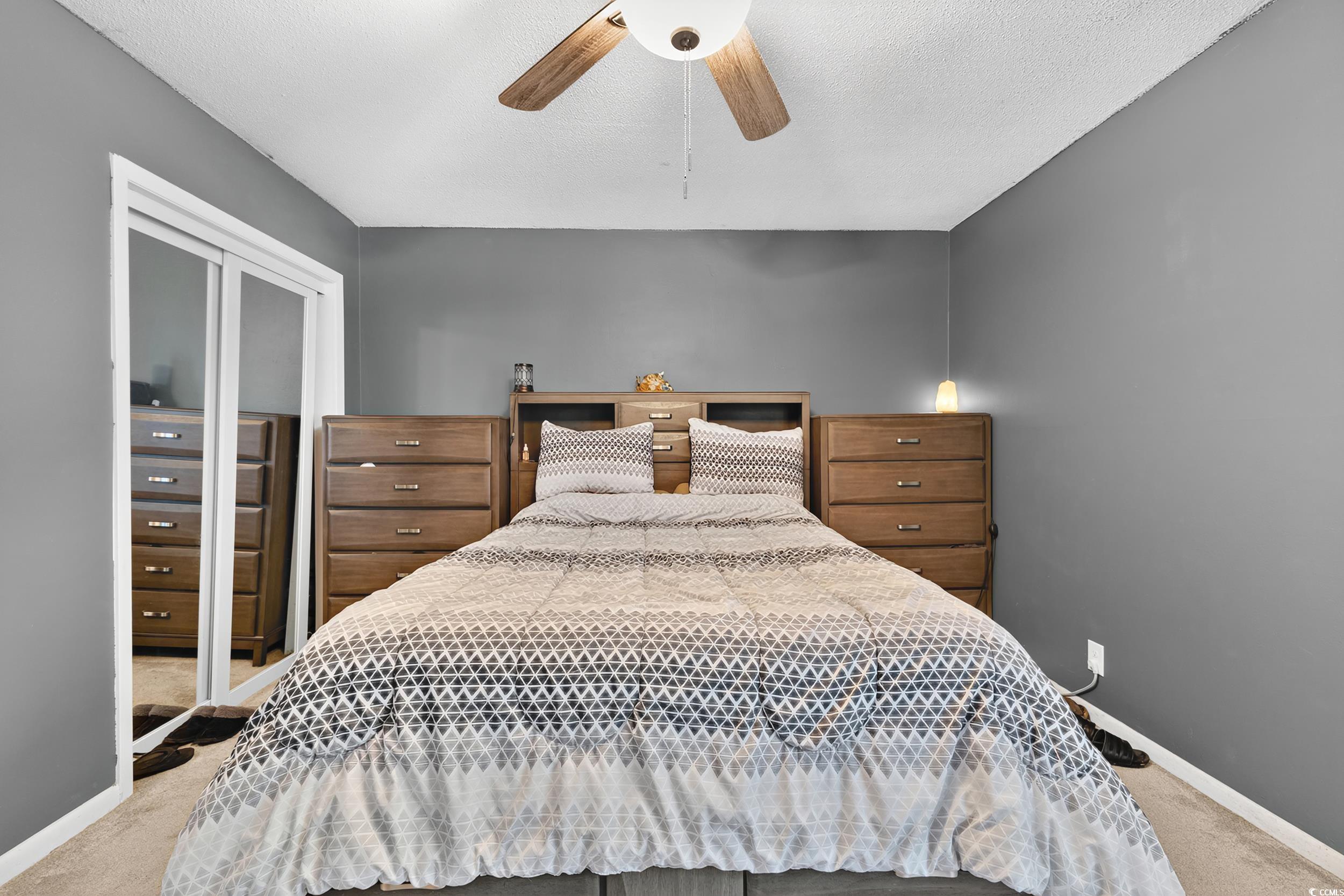 342 Red Fox Road Myrtle Beach, SC 29579 - Photo 25 of 40 Bedroom with light colored carpet, a ceiling fan, and a textured ceiling
