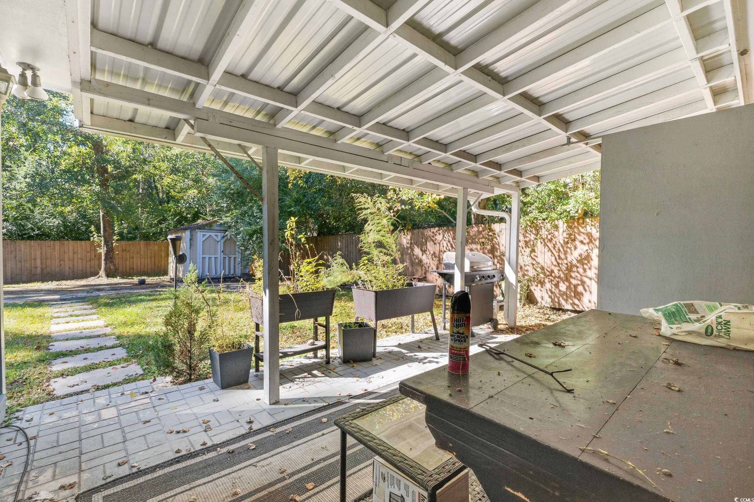 342 Red Fox Road Myrtle Beach, SC 29579 - Photo 36 of 40 Fenced backyard featuring a patio area, a shed, and a grill