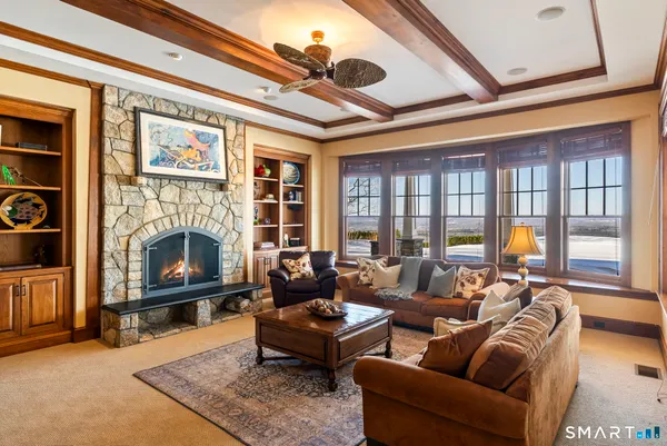 a living room with furniture a fireplace and a flat screen tv