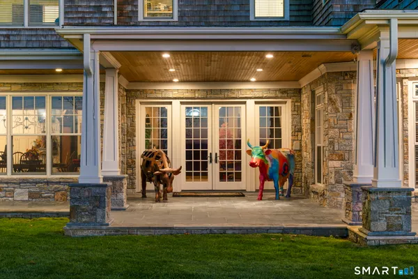 a view of a entryway door of the house with a patio