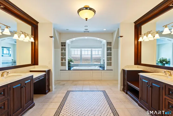 a bathroom with a tub sink and mirror