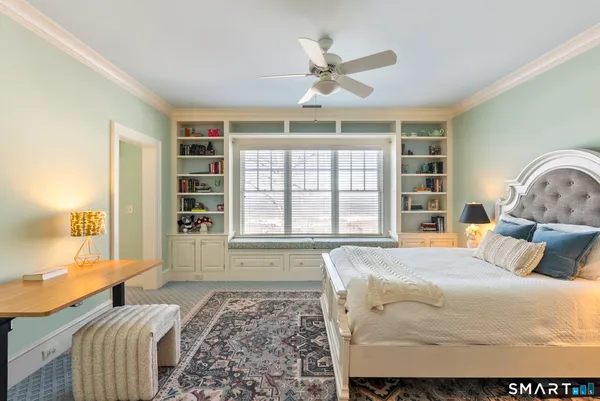 a bedroom with a large bed and a window