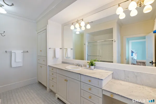 a bathroom with a double vanity sink and a mirror