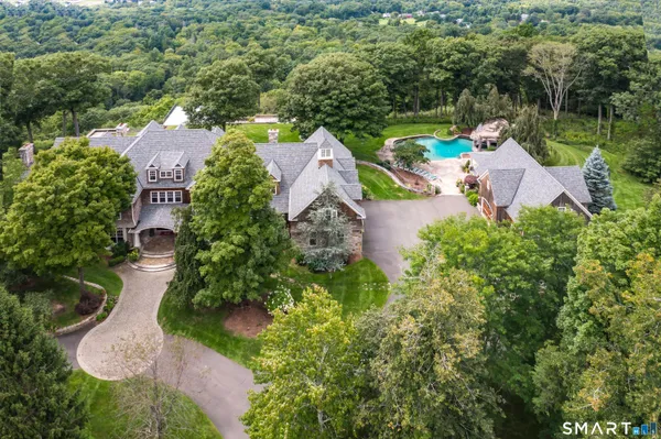 an aerial view of house with yard swimming pool and outdoor seating