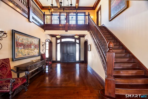 a view of entryway and hall with wooden floor