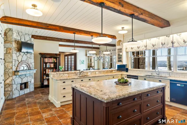a spacious bathroom with a granite countertop sink and a large mirror