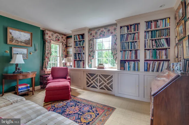 a living room with furniture and book shelf