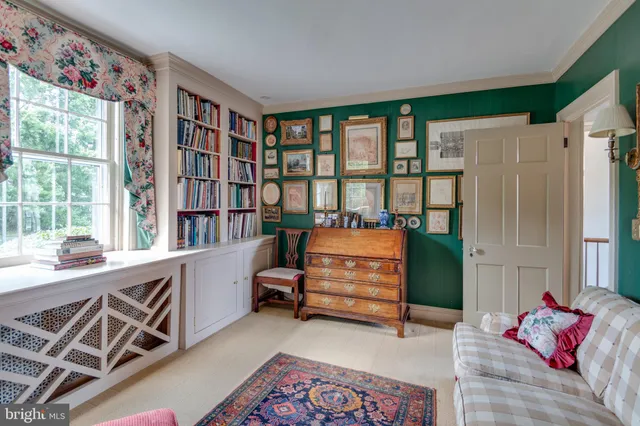 a bedroom with furniture and a book shelf