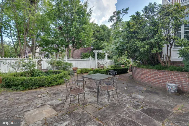 a view of a chair and table in the garden