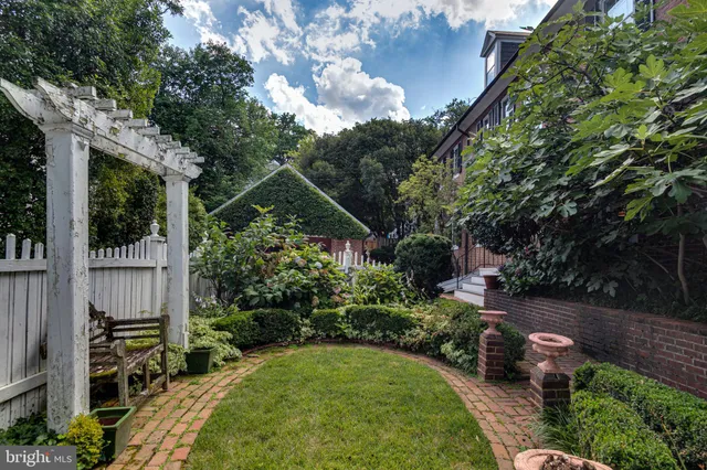 a view of backyard with plants and outdoor seating