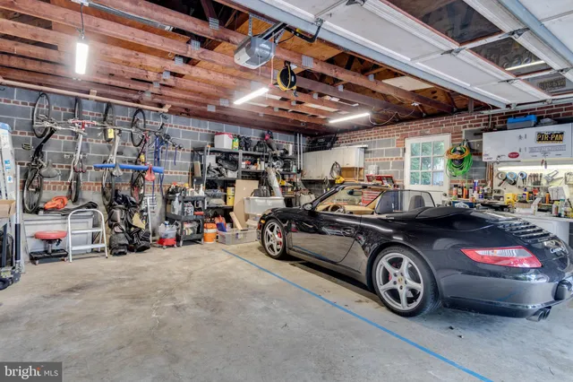 a view of parking garage with cars and a bike