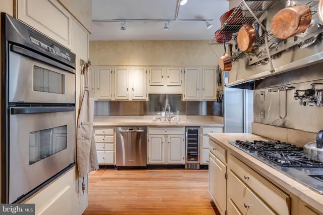 a kitchen with stainless steel appliances granite countertop a stove and a sink