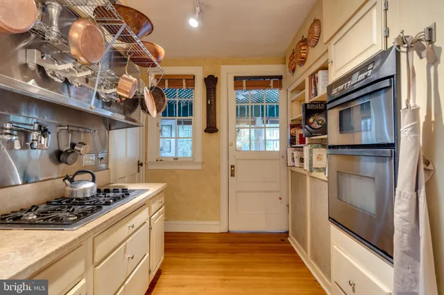a kitchen with stainless steel appliances granite countertop a stove and a refrigerator