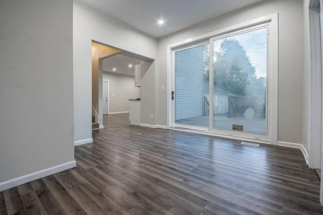 wooden floor in an empty room with a fireplace