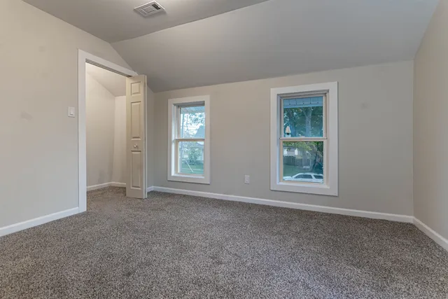 a bathroom with a granite countertop toilet a sink and mirror