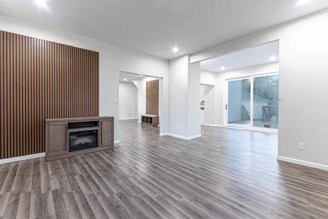 wooden floor fireplace and natural light in room