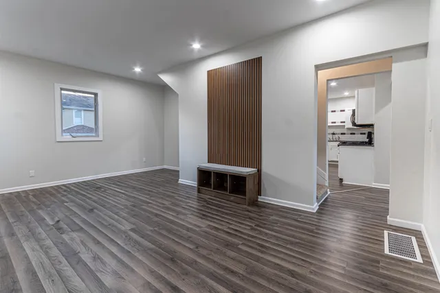 wooden floor in an empty room with a window