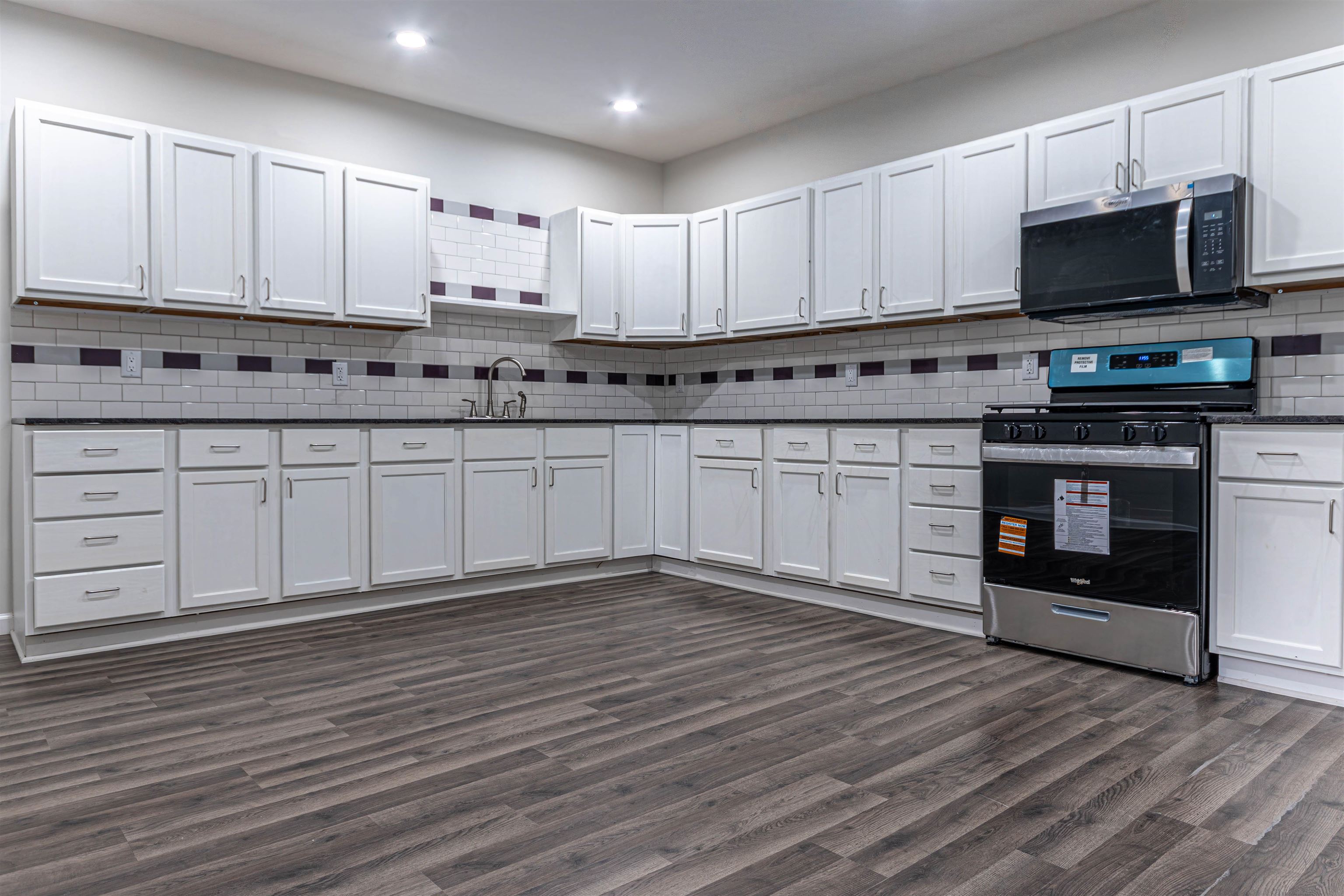 407 Allen Street Belvidere, IL 61008 - Photo 5 of 32 a kitchen with stainless steel appliances granite countertop a stove a sink and white cabinets